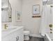 Elegant bathroom featuring modern fixtures and tub shower combination with framed coastal art at 885 Seaview Cir # 20, Crystal Beach, FL 34681