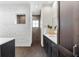 Modern bathroom with stone accent wall, vanity with dark wood cabinets, and tiled shower at 885 Seaview Cir # 20, Crystal Beach, FL 34681
