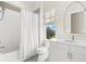 Bright bathroom features a shower-tub combo and a window offering an outside view at 885 Seaview Cir # 20, Crystal Beach, FL 34681