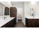 Bathroom showcasing double sink vanity with white countertops, dark wood cabinets, and decorative mirror at 885 Seaview Cir # 20, Crystal Beach, FL 34681