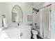 Bright bathroom featuring wallpaper and a bathtub-shower combo at 885 Seaview Cir # 20, Crystal Beach, FL 34681