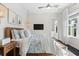 Cozy bedroom with wood accents, a large window, hanging lights, and coastal-themed artwork at 885 Seaview Cir # 20, Crystal Beach, FL 34681