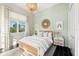 Brightly lit bedroom features wood trim, decorative lighting, and a large window at 885 Seaview Cir # 20, Crystal Beach, FL 34681
