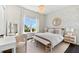 Bright bedroom features a patterned accent wall, a chandelier, bench seating, and a beautiful water view at 885 Seaview Cir # 20, Crystal Beach, FL 34681