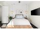 Well-lit bedroom features modern decor, a flat screen television, and hanging lights at 885 Seaview Cir # 20, Crystal Beach, FL 34681