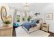 Stylish bedroom with large windows, providing abundant natural light, blue bedding, and wood floors at 885 Seaview Cir # 20, Crystal Beach, FL 34681