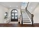 Elegant foyer with grand staircase, dark wood floors, and stylish decor at 885 Seaview Cir # 20, Crystal Beach, FL 34681