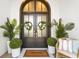 Inviting front entrance with double doors, potted plants, and a charming 'Welcome' mat at 885 Seaview Cir # 20, Crystal Beach, FL 34681