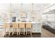 Bright kitchen features white cabinets, a large island with seating, stainless steel appliances and modern light fixtures at 885 Seaview Cir # 20, Crystal Beach, FL 34681