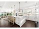 Open-concept kitchen features a large island with seating, stainless steel appliances, and modern pendant lights at 885 Seaview Cir # 20, Crystal Beach, FL 34681