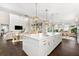 Open kitchen featuring a central island, modern pendant lighting, and seamless flow to the living area at 885 Seaview Cir # 20, Crystal Beach, FL 34681