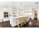 Stylish kitchen with white cabinetry, stainless steel appliances, a large island, and modern pendant lighting at 885 Seaview Cir # 20, Crystal Beach, FL 34681