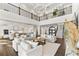 Open-concept living room with soaring ceilings and modern decor, seamlessly connecting to the kitchen at 885 Seaview Cir # 20, Crystal Beach, FL 34681