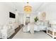Bright main bedroom features a luxury chandelier, accent wall, and sitting area at 885 Seaview Cir # 20, Crystal Beach, FL 34681