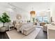 The main bedroom is spacious and features a seating area, desk, windows with waterfront view, and a chandelier at 885 Seaview Cir # 20, Crystal Beach, FL 34681