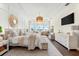 A bright main bedroom features a decorative wall, decorative mirror, chandelier, desk, and waterfront views at 885 Seaview Cir # 20, Crystal Beach, FL 34681