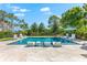 Beautiful backyard with a sparkling pool, surrounded by lush landscaping and lounge chairs for relaxation at 885 Seaview Cir # 20, Crystal Beach, FL 34681