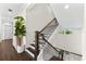 Elegant staircase with dark wood floors, white risers, and sleek black iron railing at 885 Seaview Cir # 20, Crystal Beach, FL 34681