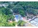 Aerial view of well-maintained tennis courts nestled in a lush, green community at 9315 Knightsbridge Ct, Tampa, FL 33647