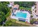 Aerial view shows the community pool and mini golf with lush landscaping at 9315 Knightsbridge Ct, Tampa, FL 33647