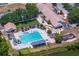 Community featuring a pool, lounge area, mini golf, and clubhouse by a lake at 9315 Knightsbridge Ct, Tampa, FL 33647