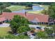 Aerial view of clubhouse with parking and manicured landscaping near a golf course at 9315 Knightsbridge Ct, Tampa, FL 33647
