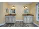 Bathroom showcasing dual sink vanities with granite counters and decorative mirrors at 9315 Knightsbridge Ct, Tampa, FL 33647