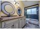 Updated bathroom features dual sinks, granite counters, framed mirrors, and a shower/tub combo at 9315 Knightsbridge Ct, Tampa, FL 33647