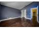Bedroom with hardwood floors, and a view into the bathroom and closet at 9315 Knightsbridge Ct, Tampa, FL 33647