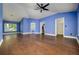 Spacious bedroom features hard wood floors, blue walls, ceiling fan, and multiple closets at 9315 Knightsbridge Ct, Tampa, FL 33647