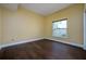 Bedroom with wood floors and a window at 9315 Knightsbridge Ct, Tampa, FL 33647