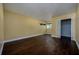 Empty bedroom boasts hardwood floors, yellow walls, baseboards, closet, and window at 9315 Knightsbridge Ct, Tampa, FL 33647
