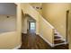 Inviting foyer with warm paint color, staircase, wood-look floors, and an open floor plan at 9315 Knightsbridge Ct, Tampa, FL 33647