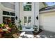 Covered front entrance with white-tiled floor, double front doors, and side-mounted lighting at 9315 Knightsbridge Ct, Tampa, FL 33647