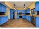 Bright kitchen featuring custom blue cabinets, stainless steel appliances, and granite countertops at 9315 Knightsbridge Ct, Tampa, FL 33647