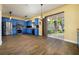Spacious eat-in kitchen featuring blue cabinets, granite countertops, stainless appliances, and natural light at 9315 Knightsbridge Ct, Tampa, FL 33647