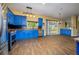 Bright kitchen with custom blue cabinets, granite countertops, and stainless steel appliances at 9315 Knightsbridge Ct, Tampa, FL 33647