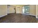Open living area with wood-look tile flooring, warm paint, and a view of the staircase at 9315 Knightsbridge Ct, Tampa, FL 33647