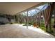 Enclosed patio features a grill, jacuzzi, curtains, tile floors, and green plants at 9315 Knightsbridge Ct, Tampa, FL 33647