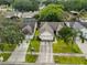 Aerial view of the home showcasing front yard, driveway and mature trees at 1005 Hardwood Dr, Valrico, FL 33596