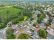Aerial view of home in a community near a small lake and golf course at 1005 Hardwood Dr, Valrico, FL 33596