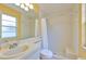 Bright bathroom featuring a shower, toilet, sink and a large mirror at 1005 Hardwood Dr, Valrico, FL 33596
