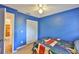 Cozy bedroom featuring a closet, doorway, and vibrant blue walls at 1005 Hardwood Dr, Valrico, FL 33596