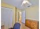 Bright bedroom with double door closet, ceiling fan, and adjacent bathroom access at 1005 Hardwood Dr, Valrico, FL 33596