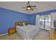 Bright bedroom with a ceiling fan, large window, and ample natural light at 1005 Hardwood Dr, Valrico, FL 33596
