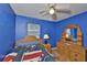 Bedroom featuring wood furniture, a ceiling fan, and a window with blinds at 1005 Hardwood Dr, Valrico, FL 33596