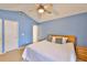 Cozy bedroom with blue walls, ceiling fan, and comfortable bed for restful nights at 1005 Hardwood Dr, Valrico, FL 33596