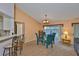 Open dining area with seating for four and sliding door access to the outside at 1005 Hardwood Dr, Valrico, FL 33596