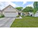 Inviting single-story home showcasing a two-car garage, lush green lawn, and vibrant landscaping at 1005 Hardwood Dr, Valrico, FL 33596