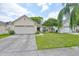 Charming single-story home featuring an attached two-car garage and a well-manicured lawn at 1005 Hardwood Dr, Valrico, FL 33596